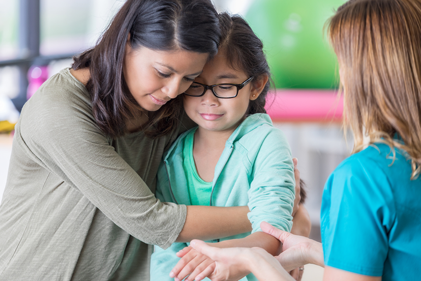 Mom comforts injured child